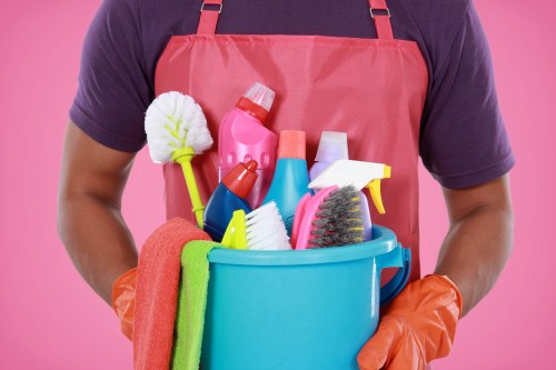 Professional cleaner wearing PPE while preparing supplies
