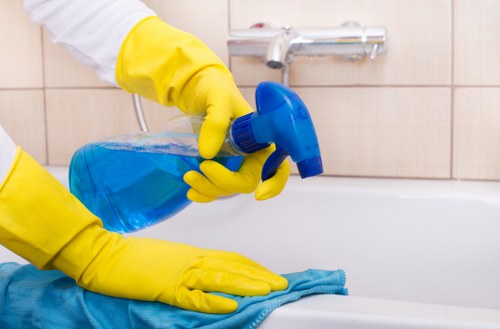 Cleaner working in a compact central London kitchen in Soho